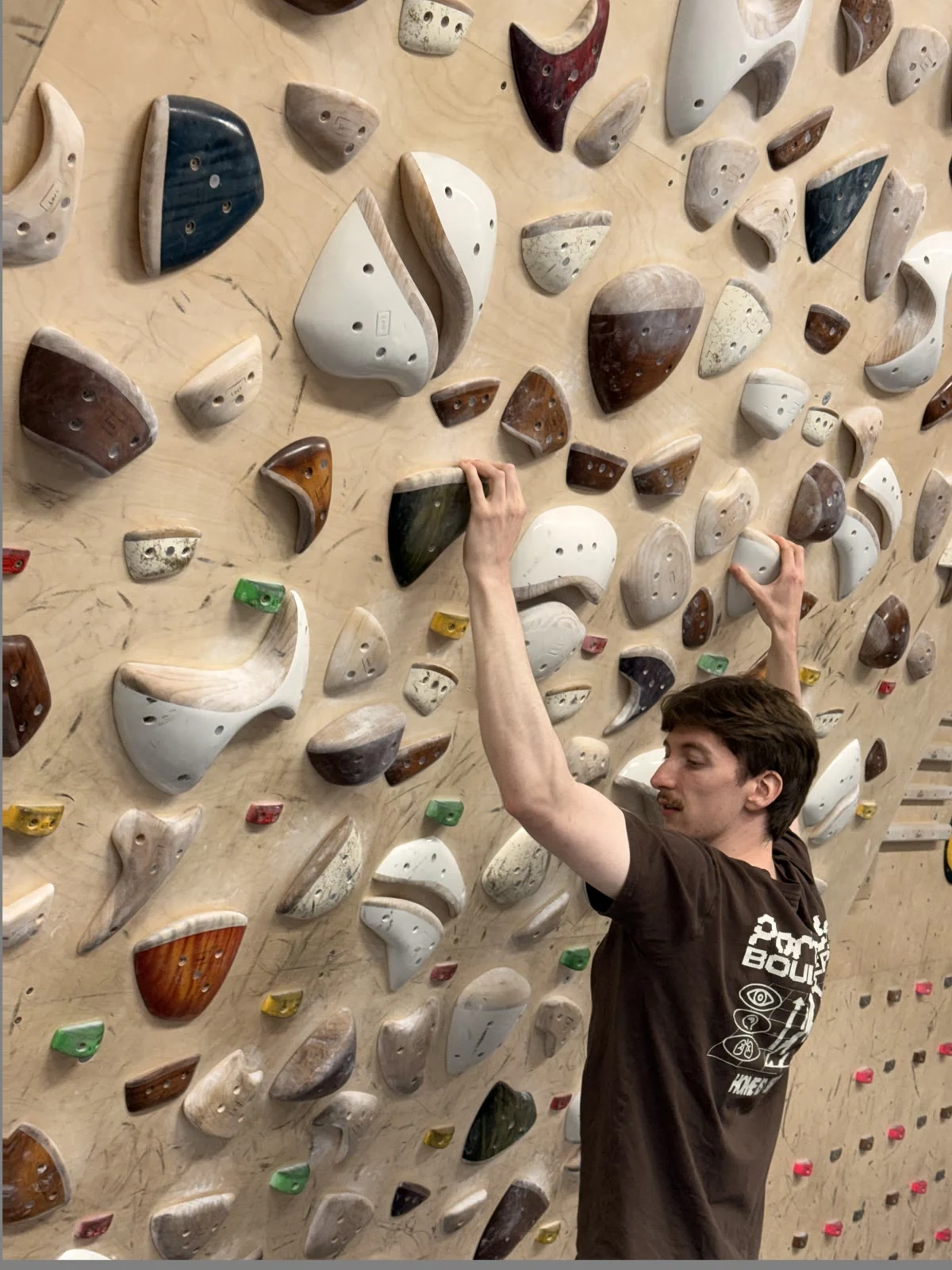 A Beta Physio founder climbing an indoor bouldering wall